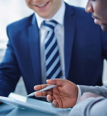 Two businessmen discussing computer project